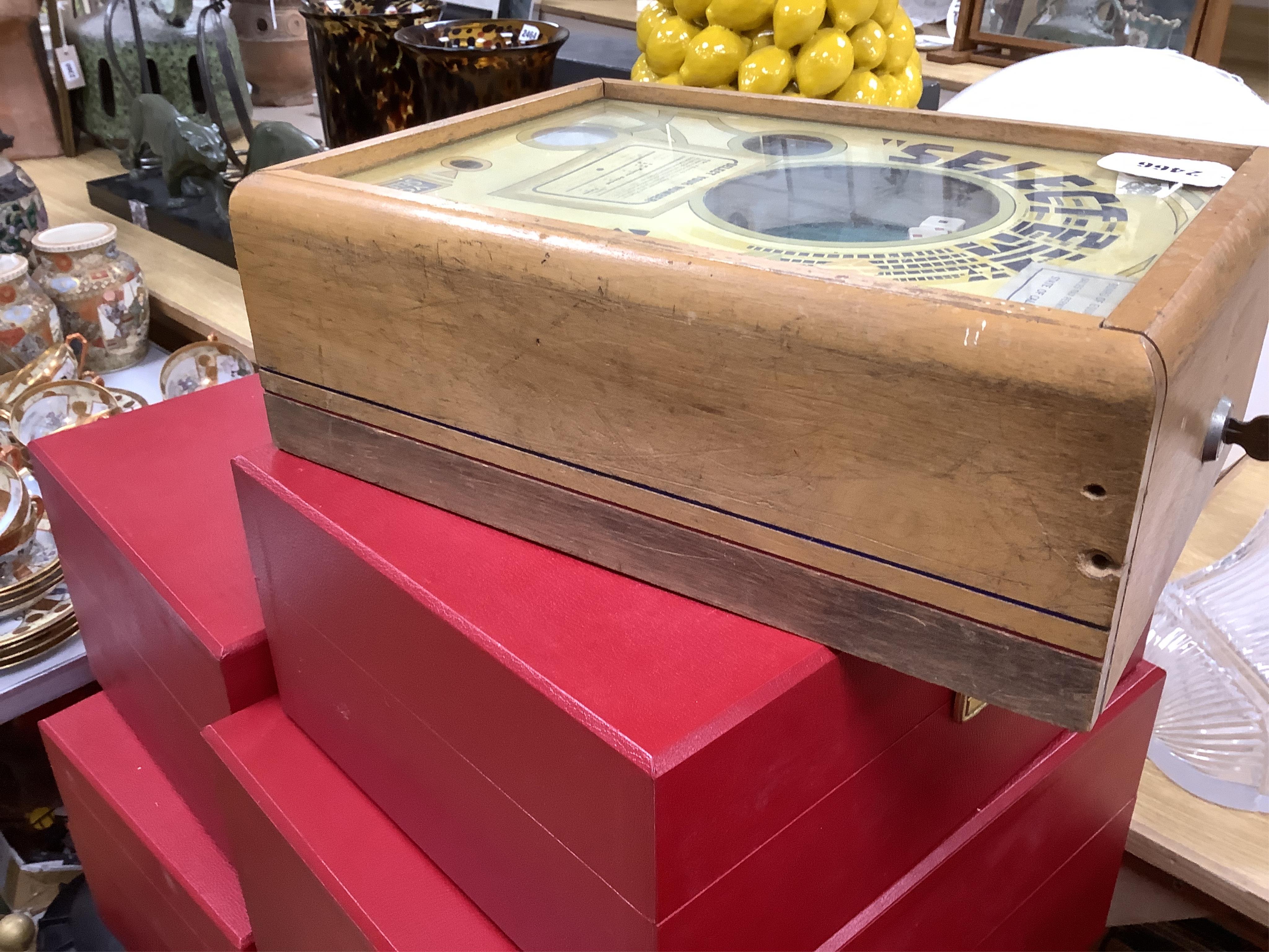 A ‘Select-Em’ table top pinball style dice game in a teak frame dated 1933, with Board of Equalization sales tax permit label for the State of California, 26cm wide, 35.5cm deep, 12.5cm high